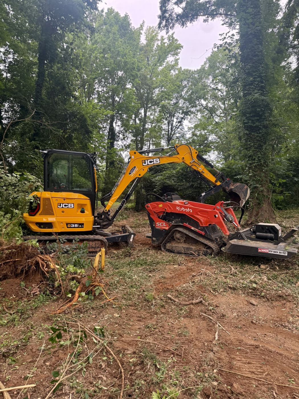 Mini excavator and compact tracked loader on Urban’s Mint Hill clearing project